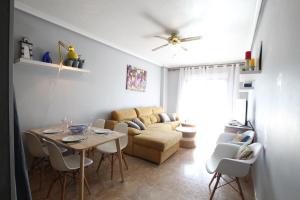 a living room with a table and a couch at Apartamento LAVANDA , Costamarina, Cabo Roig in Orihuela Costa