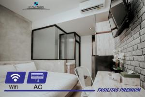 a room with a bed and a table in it at DPARAGON KEMUNING in Yogyakarta
