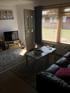 a living room with a couch and a table at Moonlight Ridge in Dartmouth