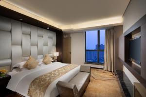 a bedroom with a large bed and a large window at Ramada by Wyndham Xian Long march in Jixian