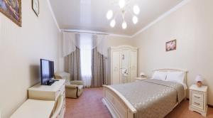 ブデンノフスクにあるHotel Nevskyの白いベッドルーム(ベッド1台、テレビ付)
