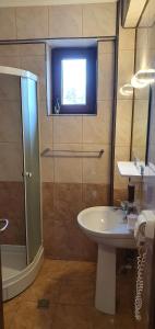 a bathroom with a sink and a shower at Vila Raduinea in Eforie Nord +28 photos