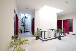 a hallway with potted plants in a building at DPARAGON SONGGOLANGIT in Malang