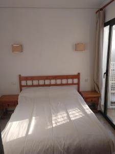 a large bed in a room with a window at Apartamento Parchís con piscina in Denia