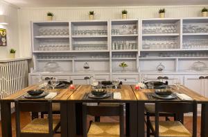 a dining room with a table with chairs and glasses at Hotel e trattoria San Giorgio in Piossasco