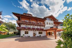 a building with balconies on the side of it at Alpines Gourmet Hotel Montanara in Flachau