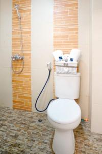 a bathroom with a toilet with a shower at DParagon Veteran in Banjarmasin