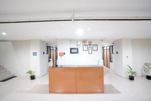 a large room with a desk in the middle of a building at DParagon Veteran in Banjarmasin