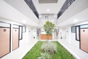 an empty hallway with a courtyard with plants at DParagon Veteran in Banjarmasin