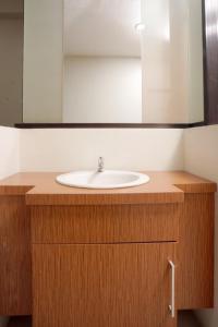 a bathroom counter with a sink and a mirror at DParagon Veteran in Banjarmasin