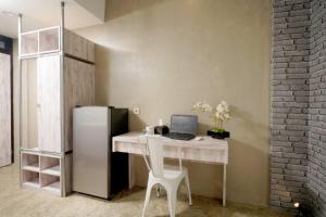 a white desk with a laptop and a refrigerator at DPARAGON KEBON JERUK in Jakarta