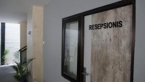 a door with a sign that reads repsons at DPARAGON KERTEN in Solo
