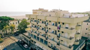 an apartment building with a view of the beach at Hotel Beverly in Rimini