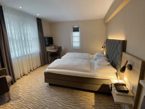 a bedroom with a large bed and a desk at Villa Huxori in Höxter