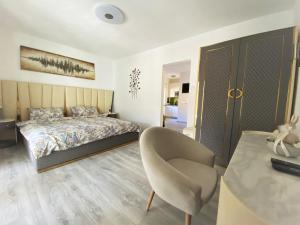 a bedroom with a bed and a chair and a table at Ferienhaus Kramser in Arnoldstein +136 photos