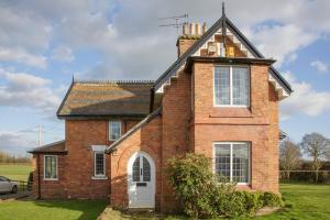 an old brick house with a chimney on top at Moss Cottage in Bickley