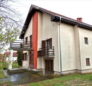 an old house with two balconies on the side of it at Vila Milica in Kraljevo