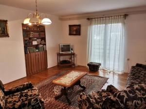 a living room with a couch and a coffee table at Vila Milica in Kraljevo