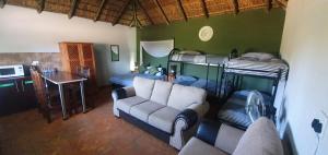 a living room with a couch and bunk beds at Tava Lingwe Game Lodge & Wedding Venue in Parys