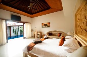 a bedroom with a large bed in a room at Taman Kesari Villas in Sanur +138 photos