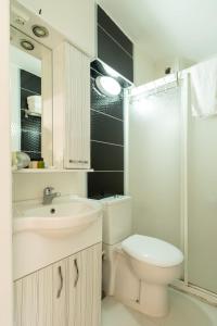 a bathroom with a toilet and a sink and a shower at LİMON OTEL FOÇA in Foça