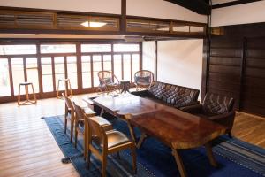 a conference room with a wooden table and chairs at tehen in Kyoto