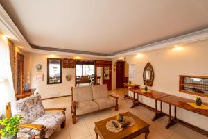 a living room with a couch and a table at LİMON OTEL FOÇA in Foça