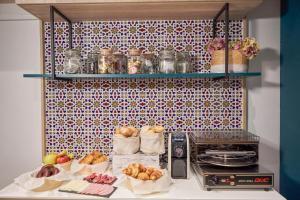 a kitchen with a counter with baskets of bread and a stove at U-Sense Sevilla Centro in Seville