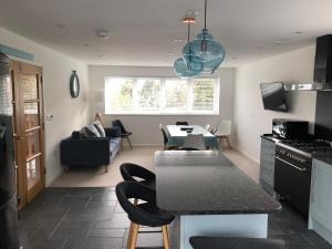 a kitchen and living room with a table and chairs at Casa Fina in St Ives