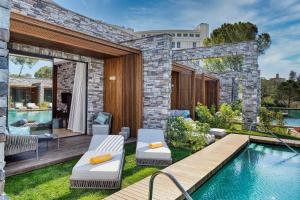a backyard with a swimming pool and a house at Kaya Palazzo Golf Resort in Belek