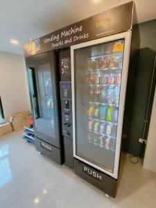two vending machines in a store with soda and drinks at ABIZZ Hotel KwanPhayao in Phayao