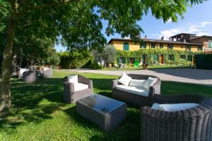 a group of wicker chairs and a table in a yard at Villa Santa Chiara in Siena
