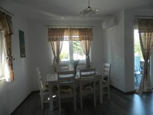 a dining room with a table and chairs at Apartman Linda in Medulin +5 photos