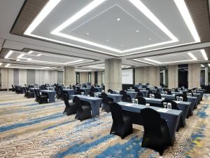 a large room with chairs and tables in it at Royal Malioboro by ASTON in Yogyakarta