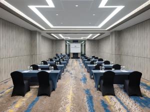a large room with tables and chairs in it at Royal Malioboro by ASTON in Yogyakarta