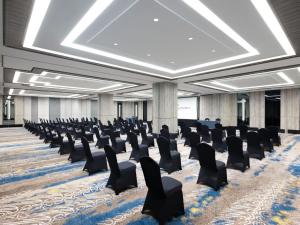 a large room with chairs and a podium in it at Royal Malioboro by ASTON in Yogyakarta