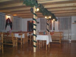 a dining room with a table with christmas decorations on a pole at Pensiunea Scarisoara in Gheţari