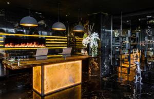 a bar with two laptops on top of a counter at H Hotel & SPA - Adults Only in St. Julianʼs