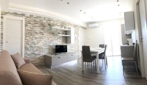 a living room with a couch and a table with chairs at La Conca in San Giovanni la Punta