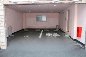 an empty parking lot with a window in a building at Hotel Sunshine in Miyazaki