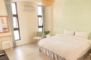 En eller flere senger på et rom på 宜蘭-讀好民宿 Read Nice House B&B 電梯民宿