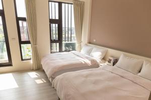 En eller flere senger på et rom på 宜蘭-讀好民宿 Read Nice House B&B 電梯民宿