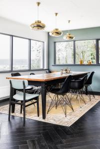 a dining room with a wooden table and black chairs at Solbakki in Flateyri