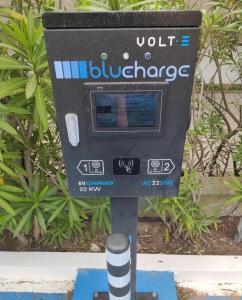 a parking meter in front of some plants at Apartamentos da Balaia in Albufeira