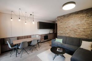 a living room with a couch and a table at Apartmán Lúčnica in Bystrá