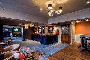 a large room with a bar and a living room at Brunel Inn in Saltash
