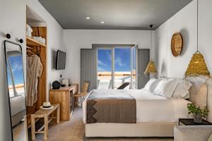 una camera da letto con un letto grande e un balcone di Lemon Suites Santorini a Firà