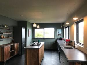 a large kitchen with a large counter top in it at Solbakki in Flateyri