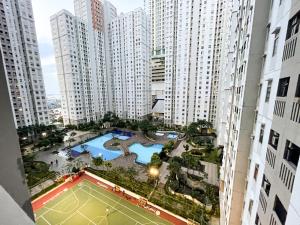 an overhead view of a tennis court in a city at Cozy Studio 1BR at Green Bay Pluit Apartment in Jakarta