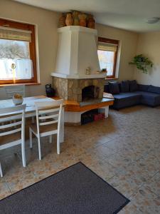 a living room with a table and a fireplace at Burai Vendégház in Villány